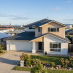 a beautiful australian home exterior in gladstone with the industrial port subtly visible in the background